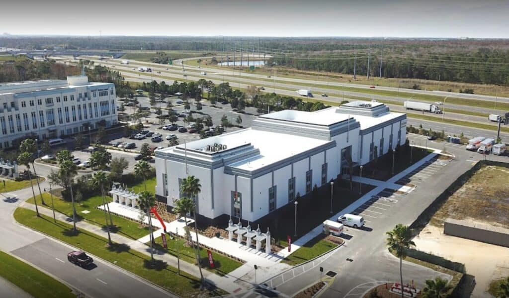Value Store It modern white storage facility exterior with dark accents and parking lot.