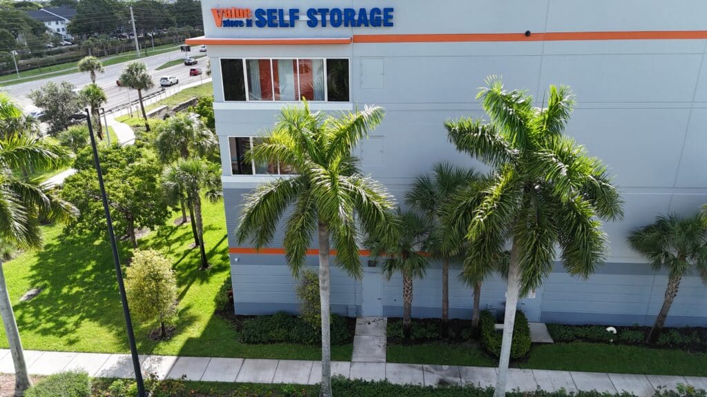Value Store It self-storage facility exterior with palm trees and green landscaping